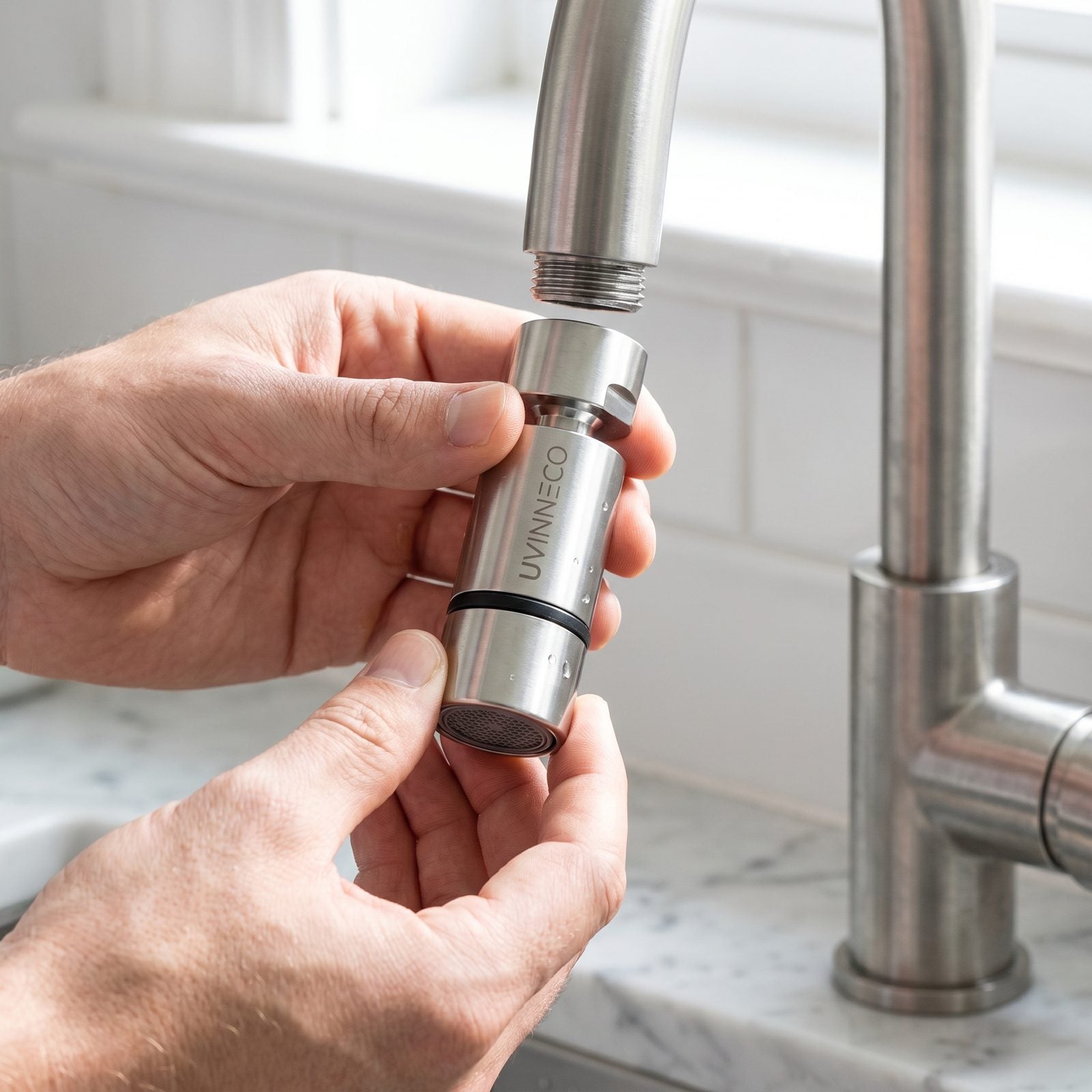 Screwing the UVINNECO attachment onto the tap thread